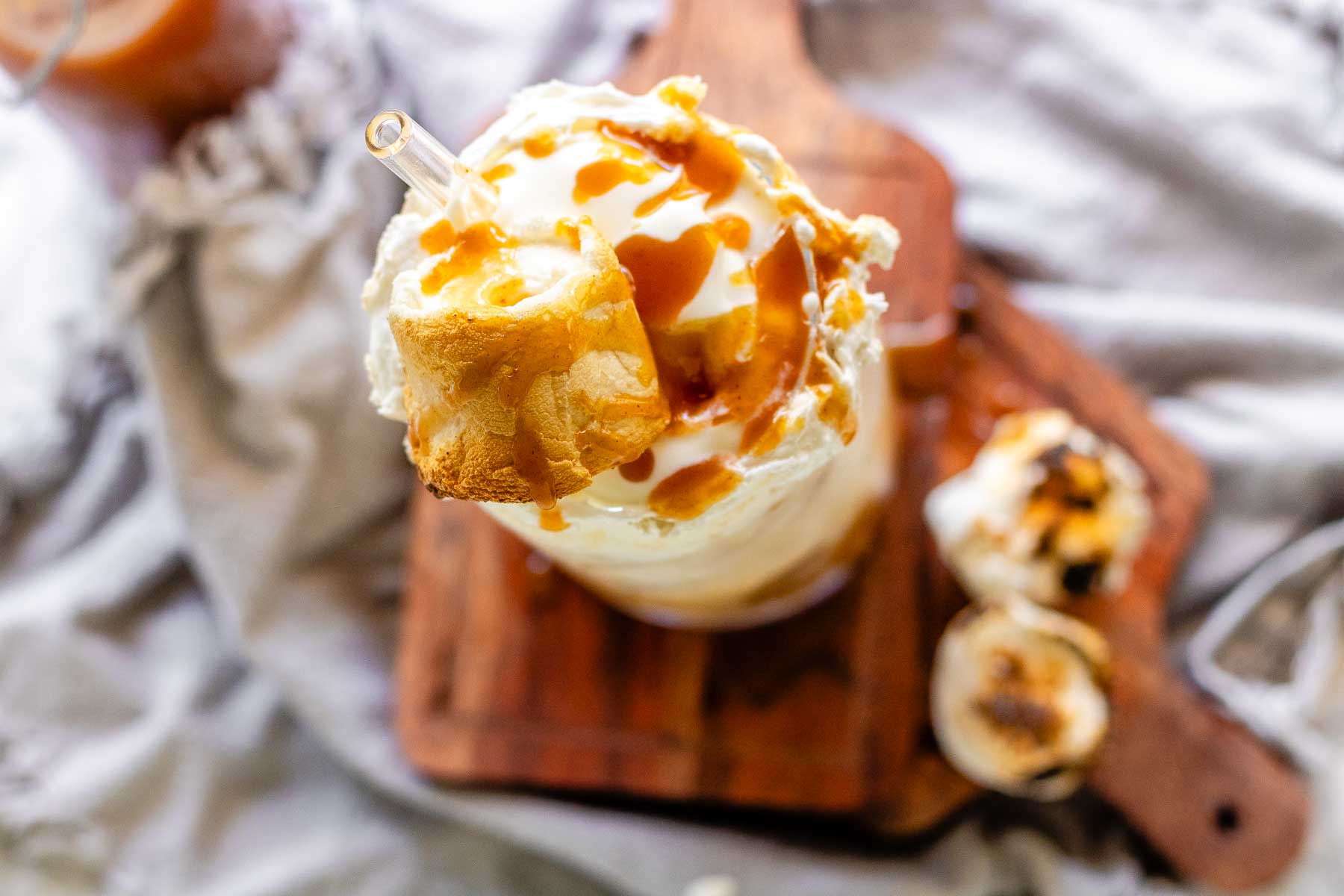 Peanut butter marshmallow iced latte with homemade syrups, topped with toasted marshmallows and peanut butter syrup drizzle.