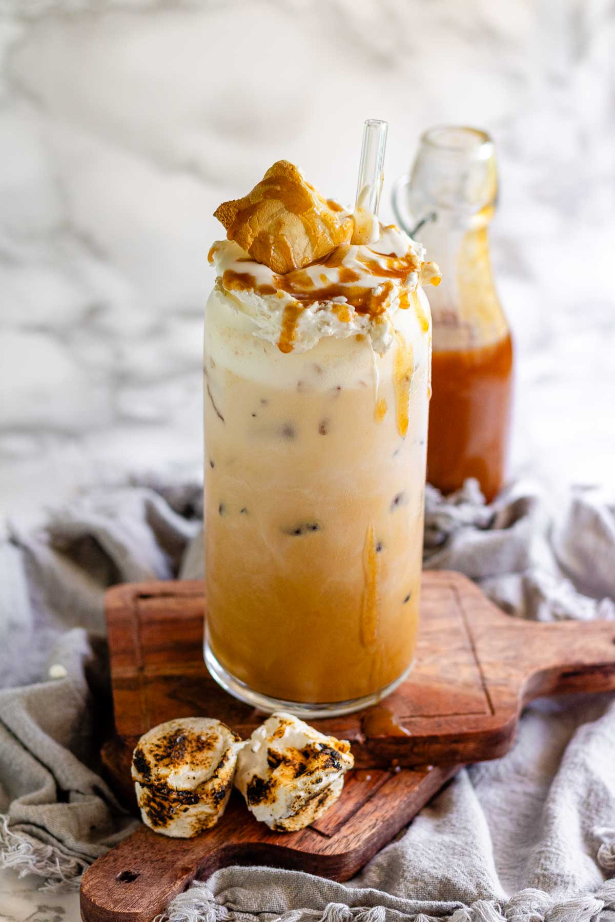 Peanut butter marshmallow iced latte with homemade syrups, topped with toasted marshmallows and peanut butter syrup drizzle.