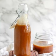 Homemade peanut butter syrup in a glass jar.