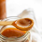 Homemade peanut butter syrup in a glass jar.
