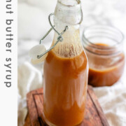 Homemade peanut butter syrup in a glass jar with the text peanut butter syrup.