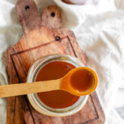 Homemade peanut butter syrup in a glass jar with the text peanut butter syrup.