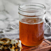 Toasted marshmallow syrup in a glass jar with toasted marshmallows.