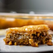 A slice of flaky, nutty pastry on a plate.