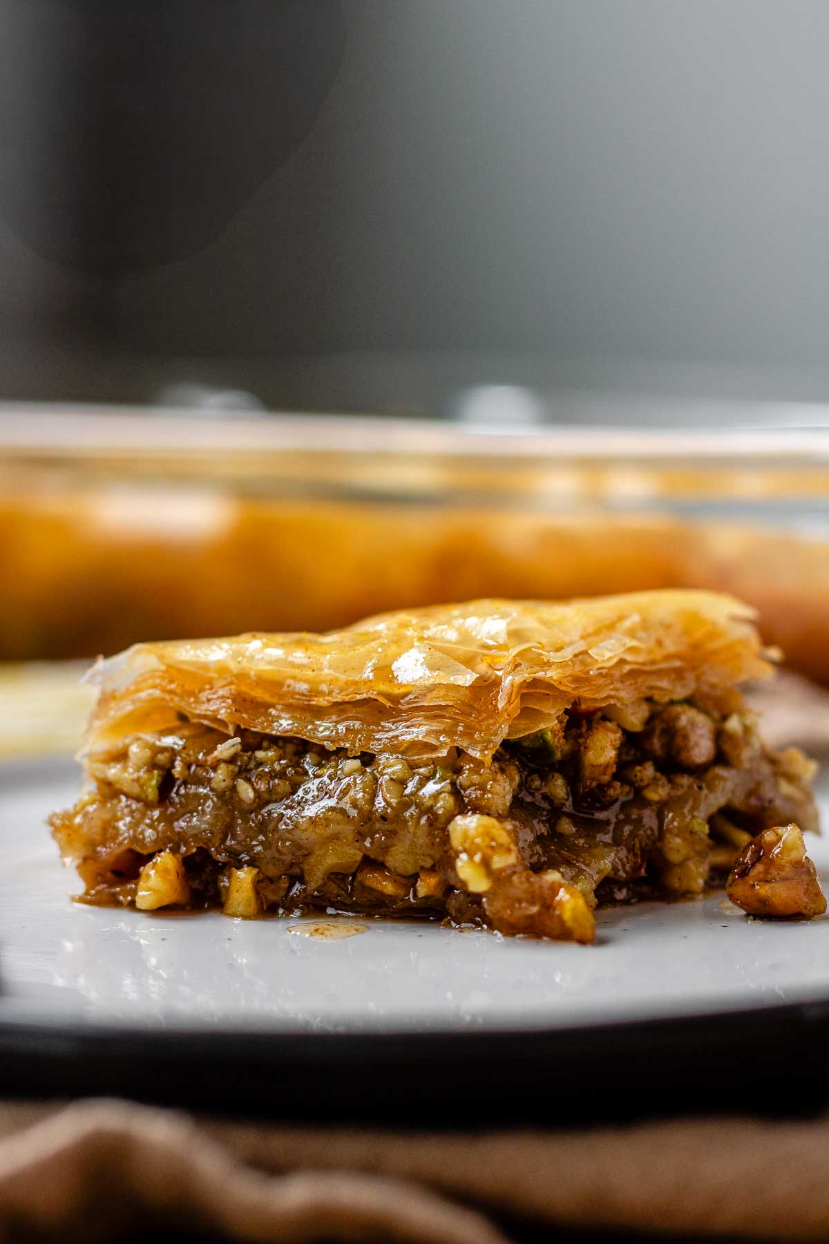 A slice of flaky, nutty pastry on a plate.