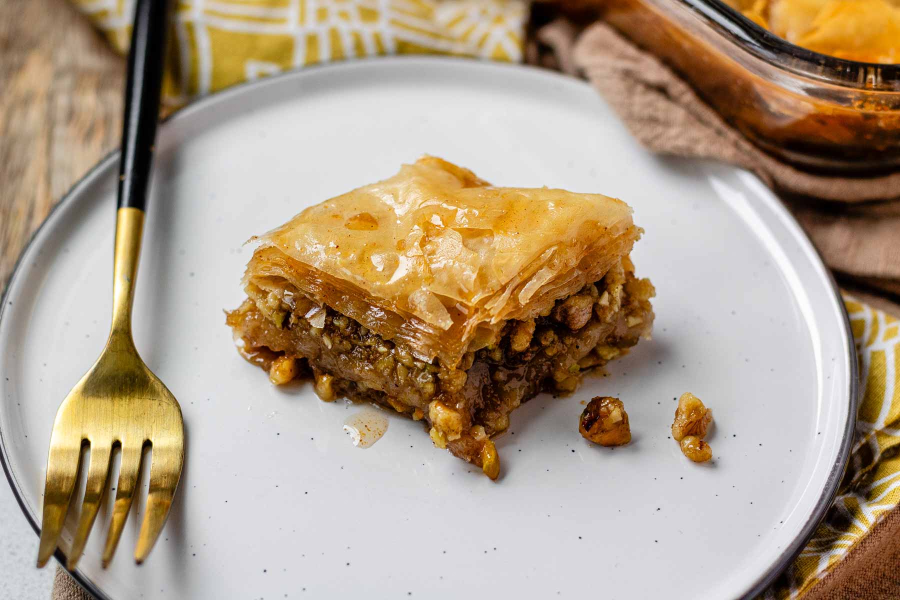 A slice of flaky, nutty pastry on a plate.