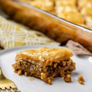 A slice of flaky, nutty pastry on a plate.