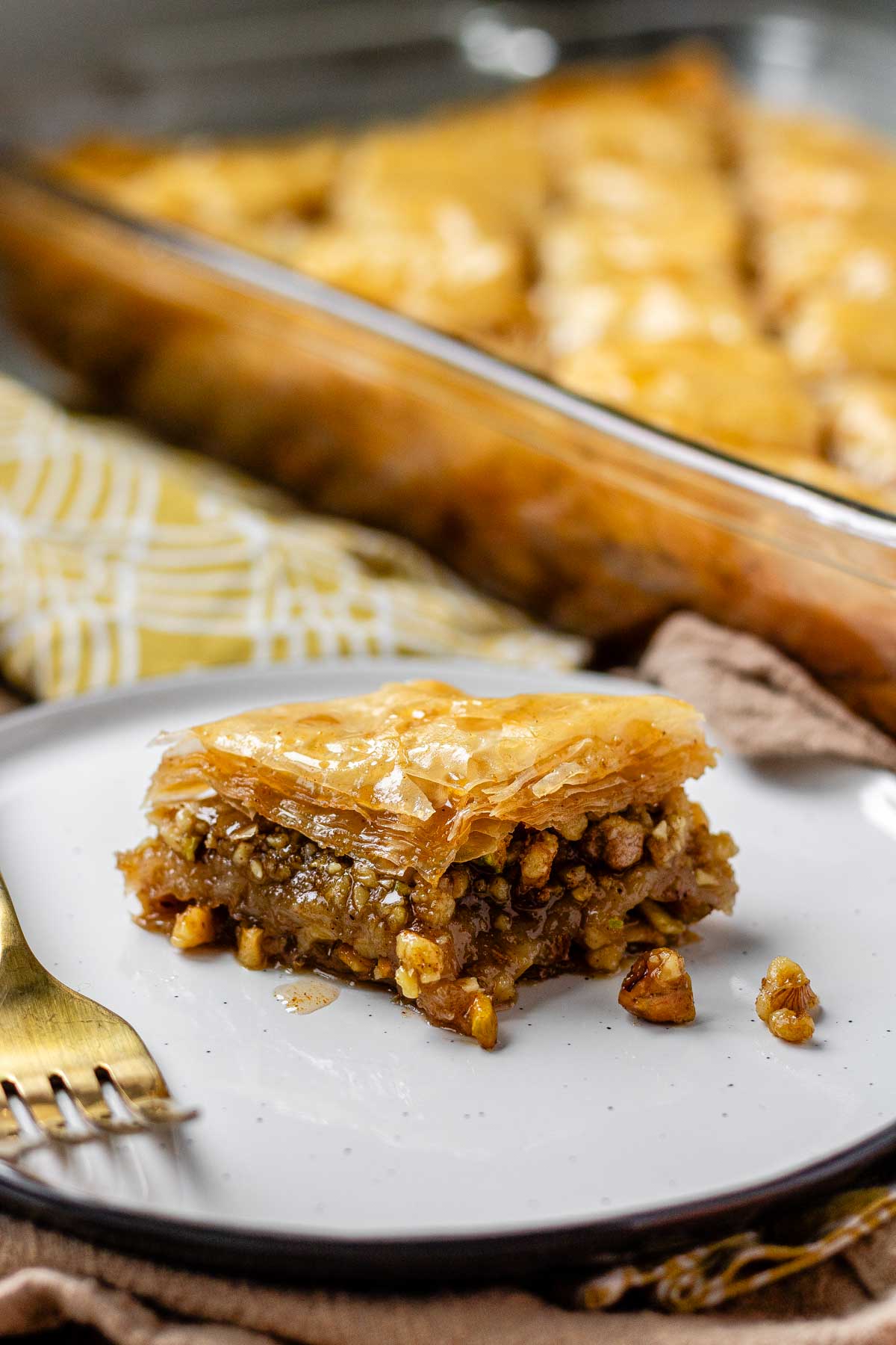 A slice of flaky, nutty pastry on a plate.