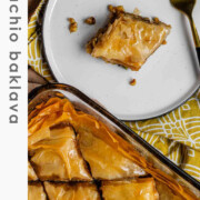 A slice of flaky, nutty pastry on a plate with the text pistachio baklava.