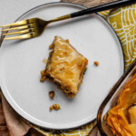 A slice of flaky, nutty pastry on a plate.