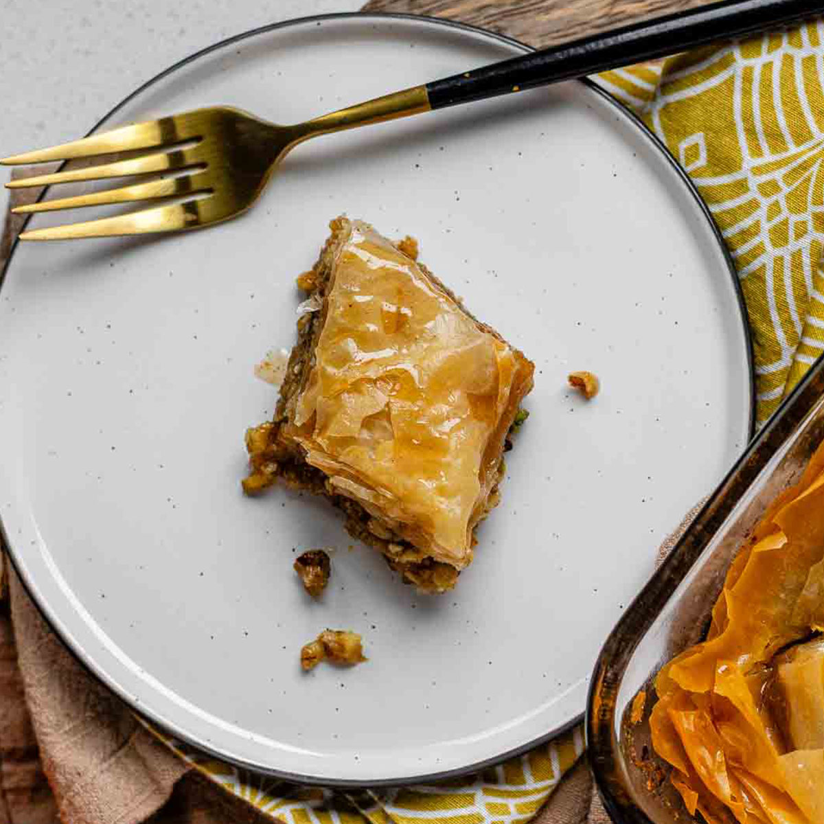 A slice of flaky, nutty pastry on a plate.