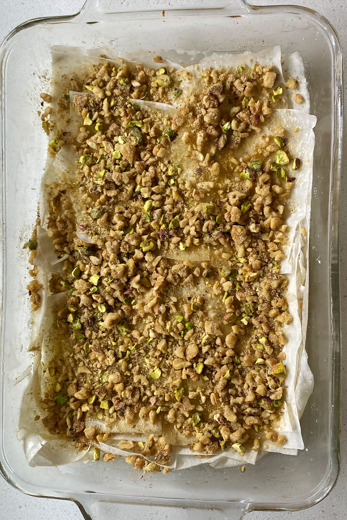 Sprinkled walnut and pistachio mixture over layers of buttered phyllo.