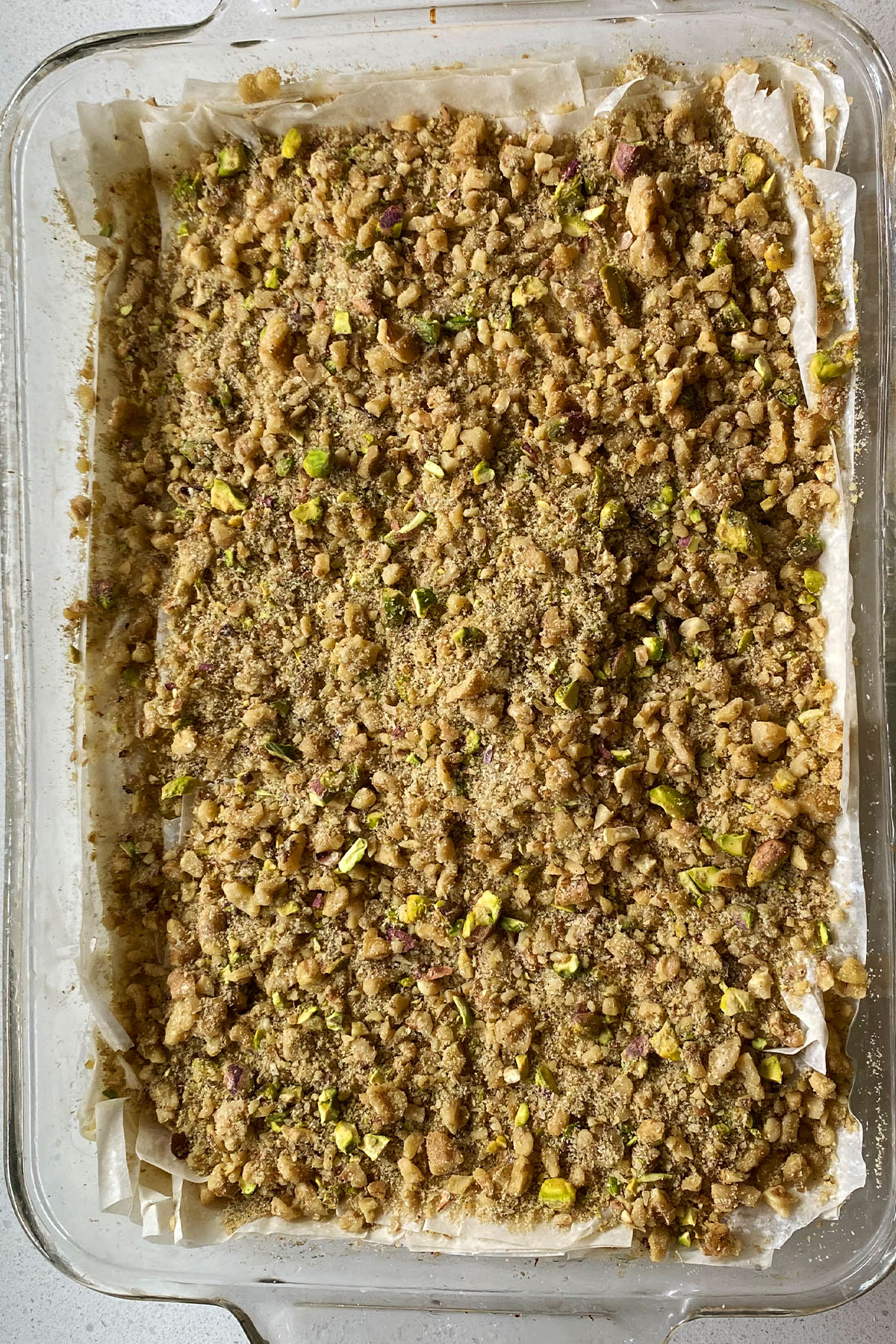 Sprinkled walnut and pistachio mixture over layers of buttered phyllo.