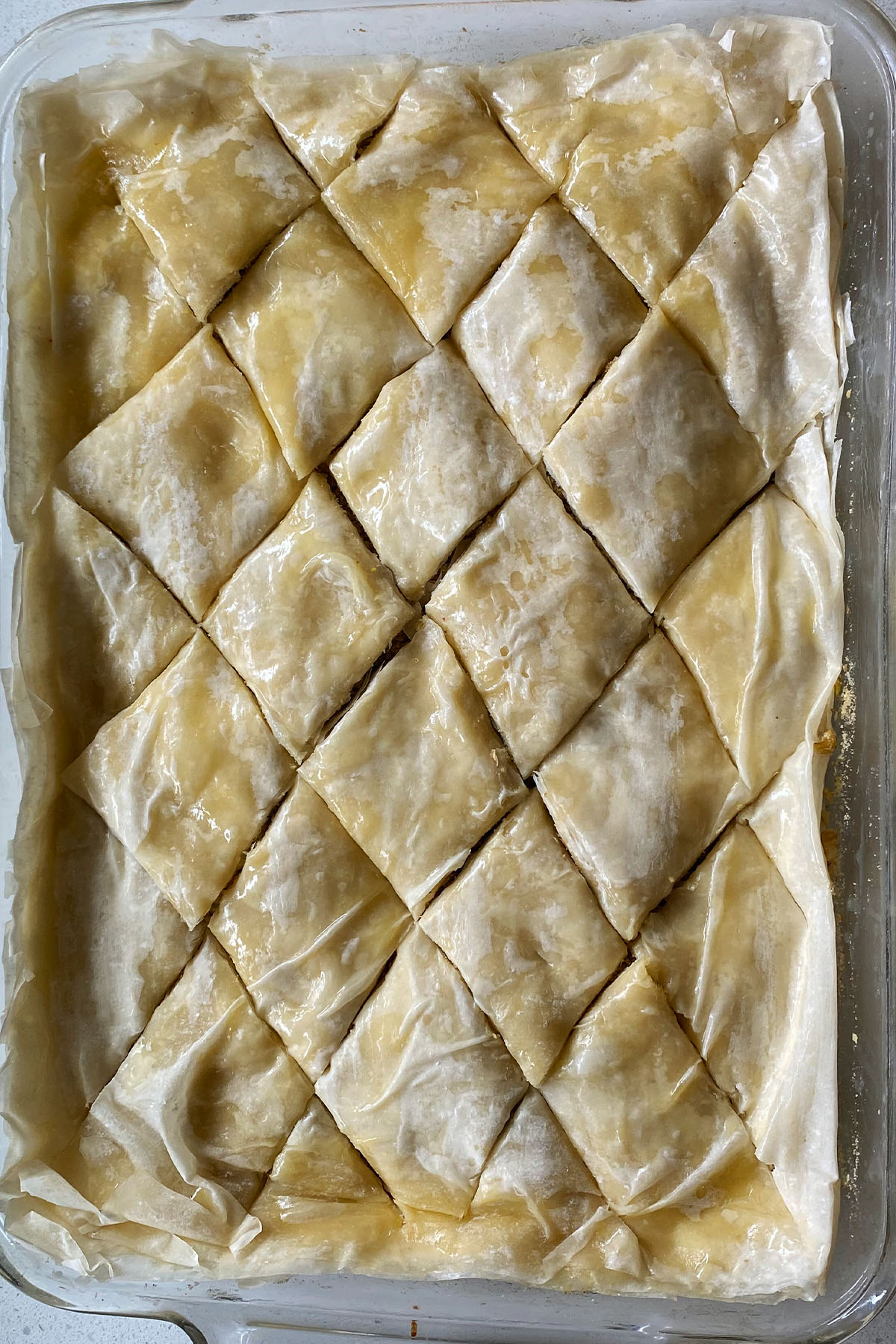 Unbaked baklava cut into diamond shapes.
