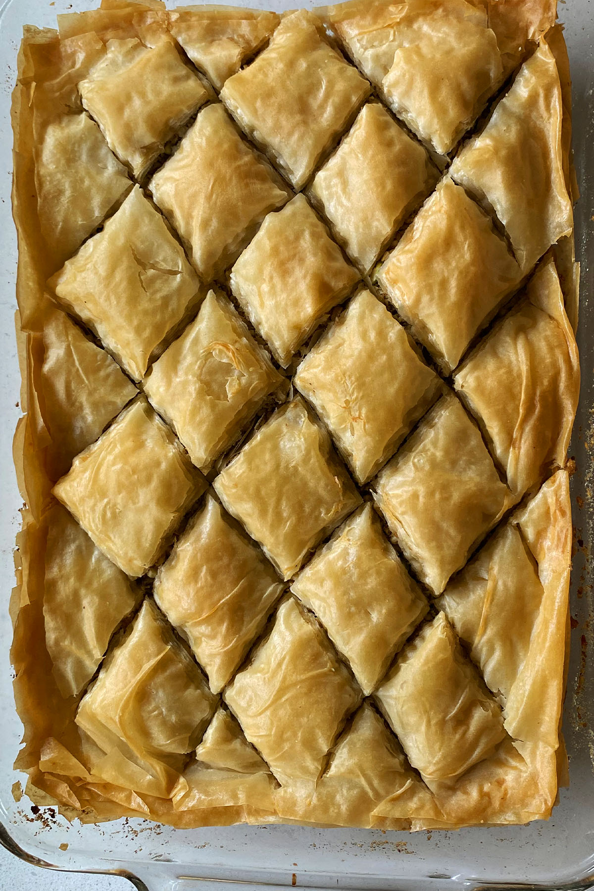 Baked baklava cut into diamond shapes.