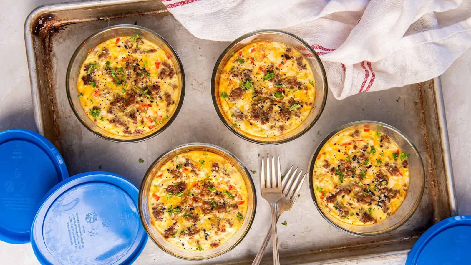 Individual egg bakes with cottage cheese, sausage, peppers, and cheese.