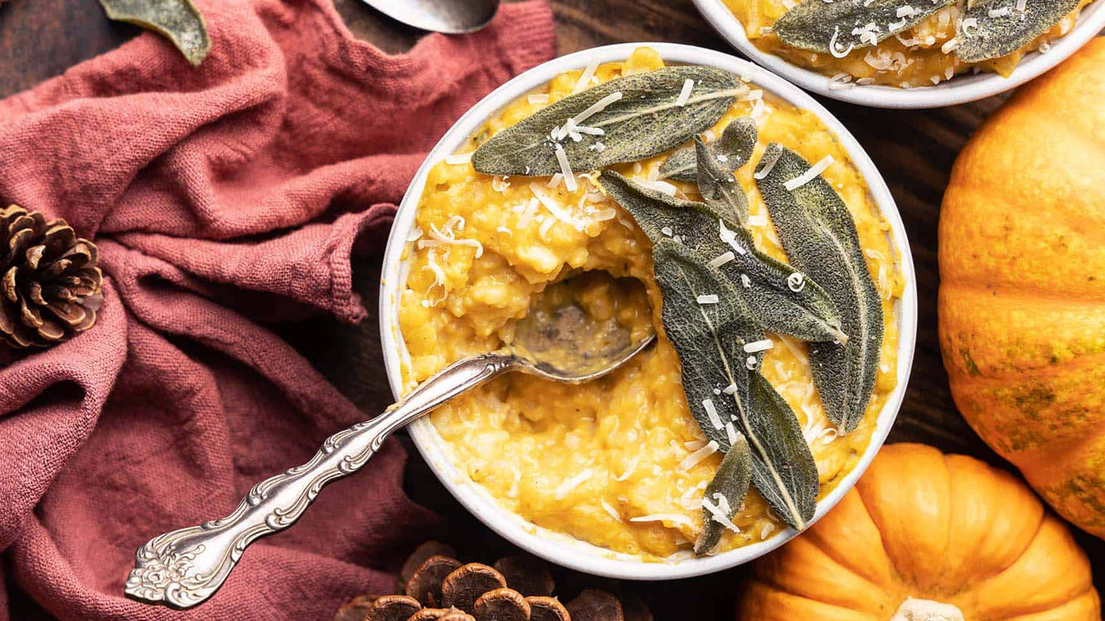 Rice in a bowl topped with sage leaves.