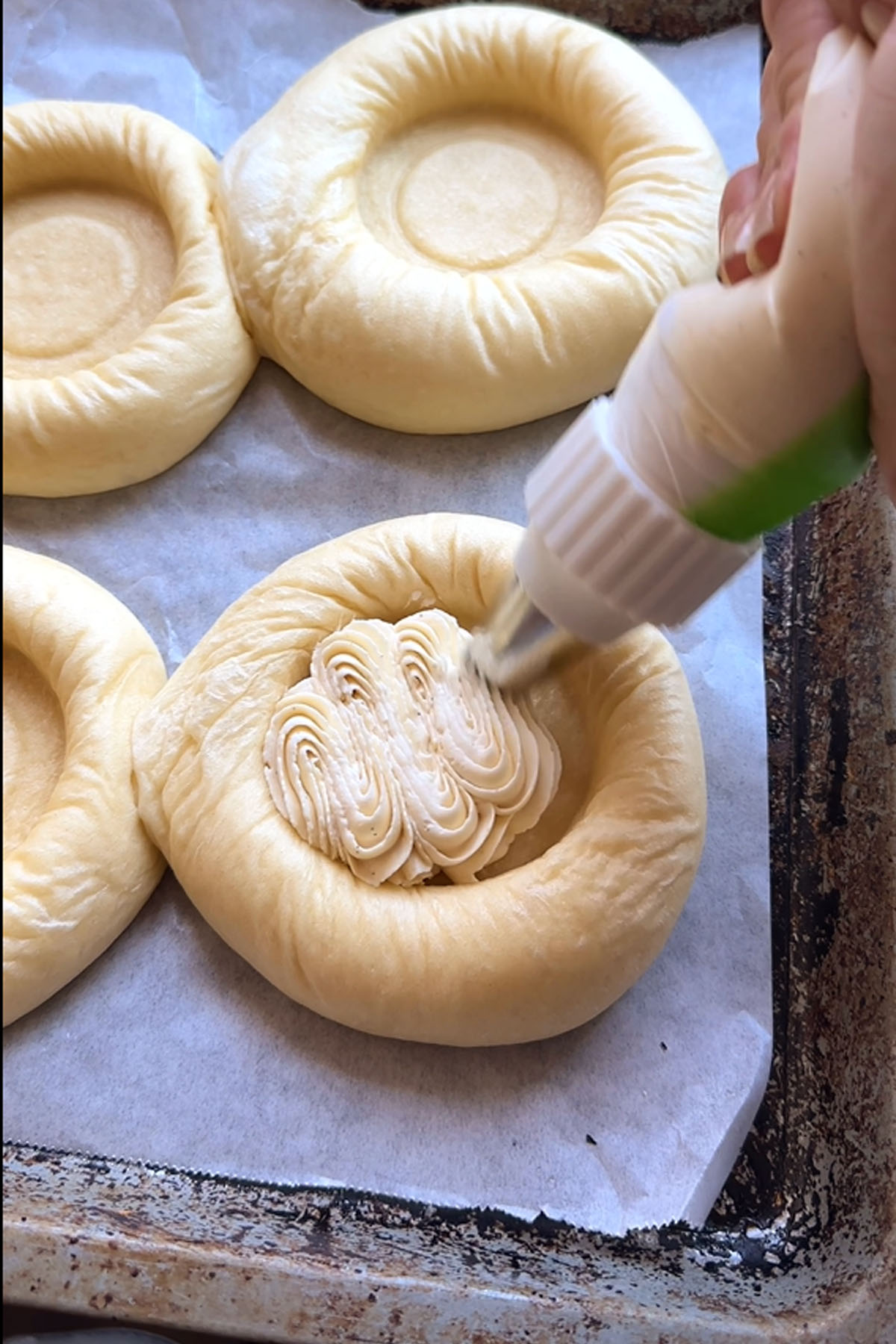 Cream cheese piped into a divot in dough.