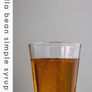 Vanilla bean syrup in a glass with the text vanilla bean simple syrup.