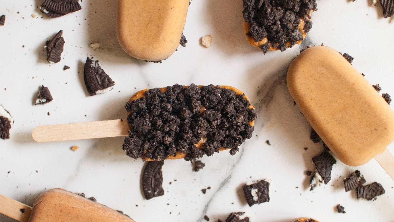 Popisicles topped with Oreo cookie crumbs.