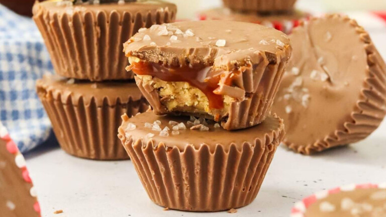 Chocolate-coated peanut butter cups, with a bite out of one.